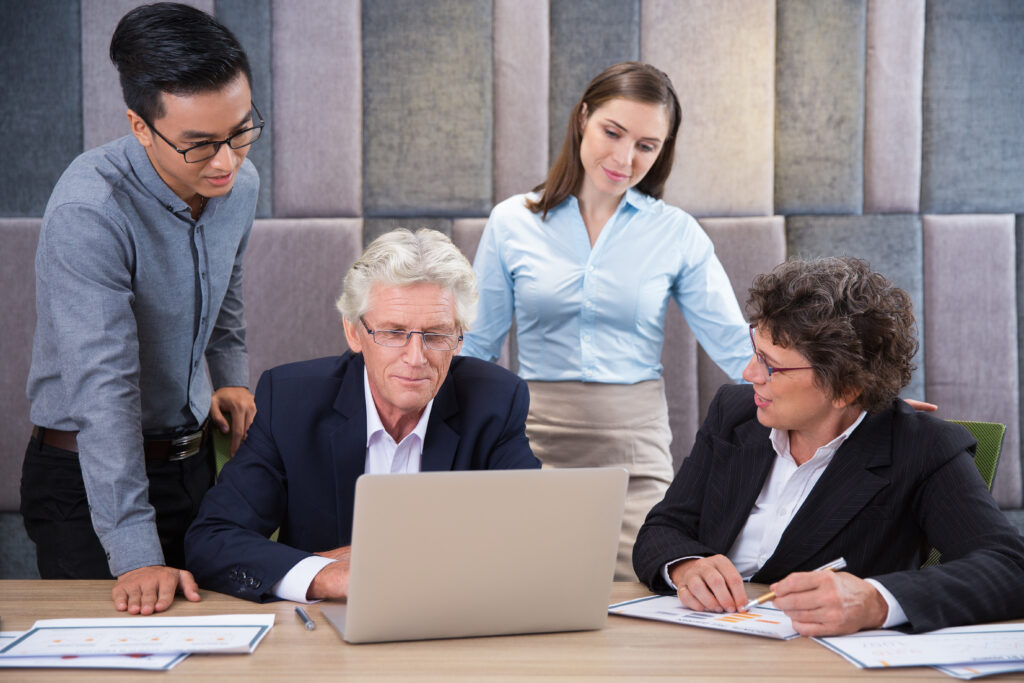 Business Team Discussing Project At Staff Meeting