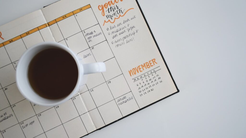 Open planning calendar with notes representing mid-year tax checkpoint and quarterly deadlines