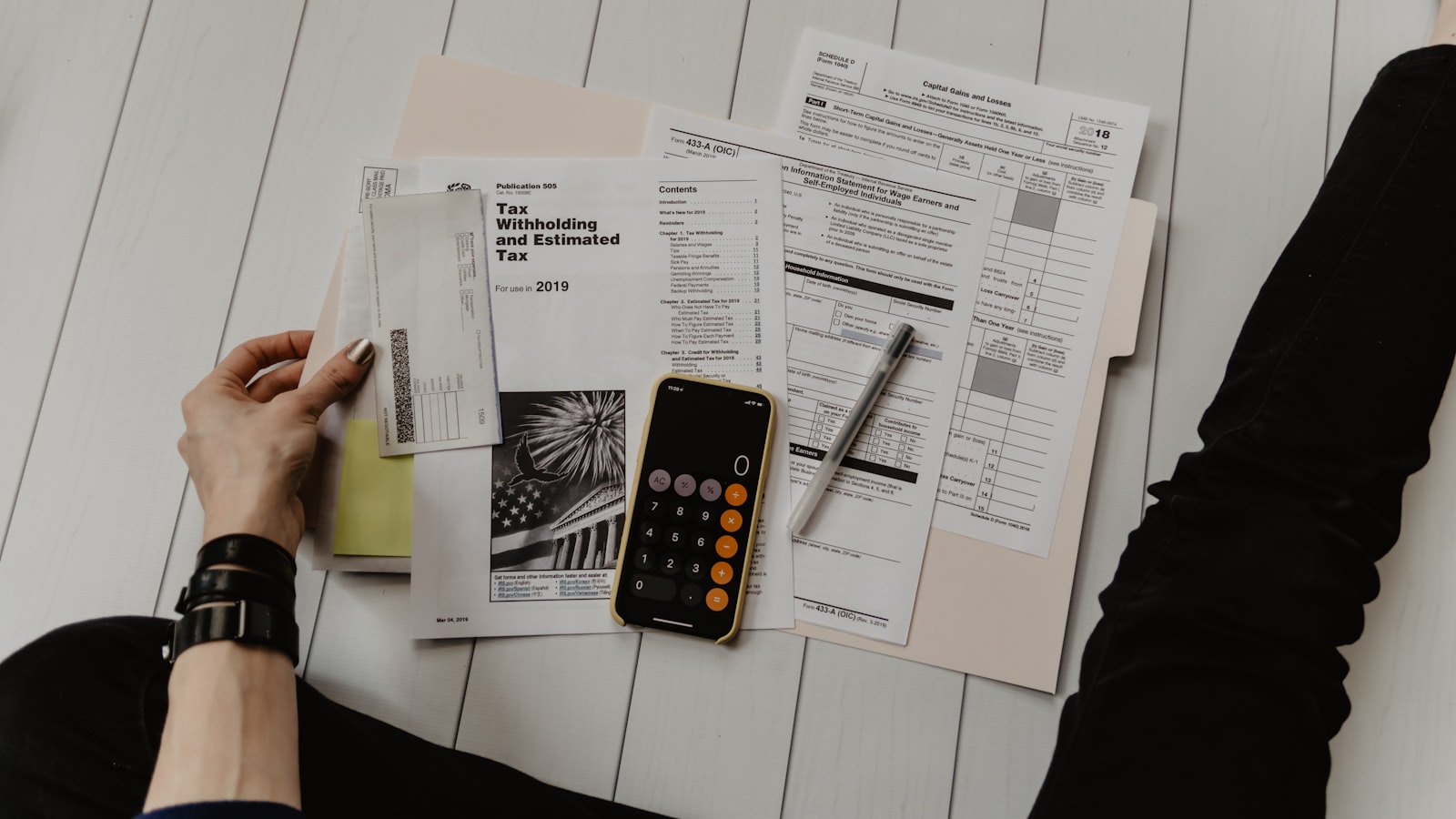 Calculator and tax paperwork on a desk representing 1099 reporting threshold updates for small businesses